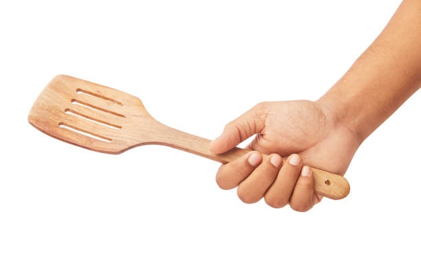 Hand holding a spatula